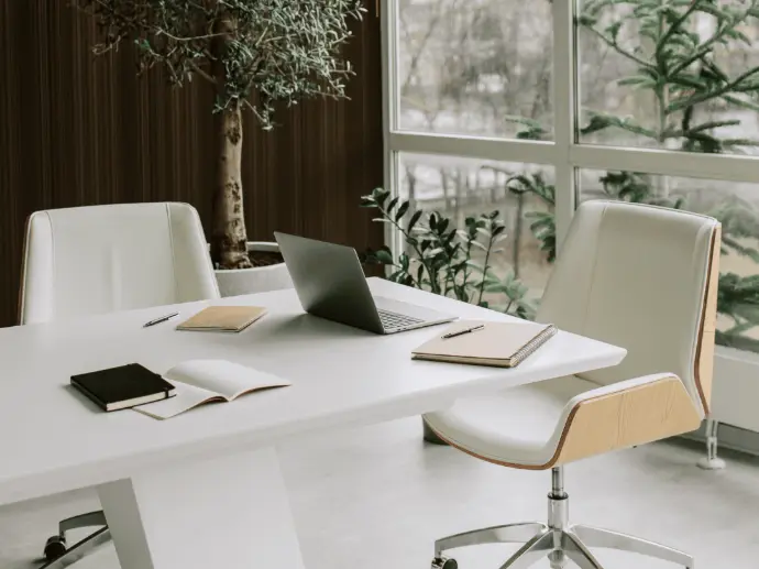 Office interior fit-out featuring glass partitions and wooden flooring